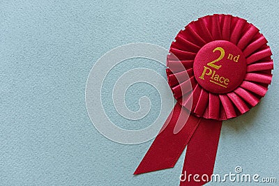 Red 2nd Place Winners rosette on light blue Stock Photo