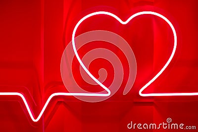Red neon heart shape and heartbeat line on metal wall Stock Photo