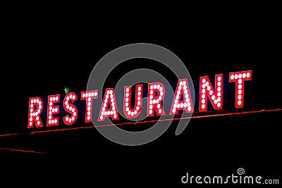 Red neon restaurant sign glowing in the night Stock Photo