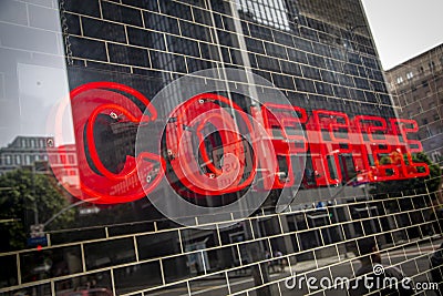 Red neon sign reading COFFEE tilted at angle Stock Photo