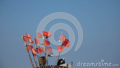 Red net marker flags on a traditional fishing boat, copy space Stock Photo