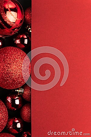 Red New Year tree toys top view background. Xmas decorations. Winter holidays backdrop with copyspace. Christmas composition with Stock Photo