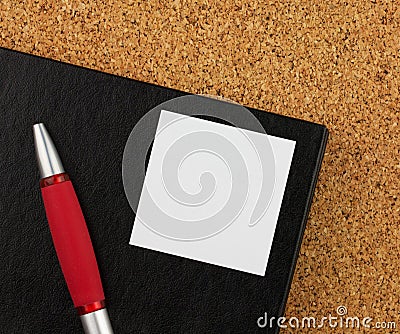 Red notebook and black glases on the cork board Stock Photo