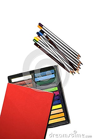 Red notepad and colored paints on a white background Stock Photo