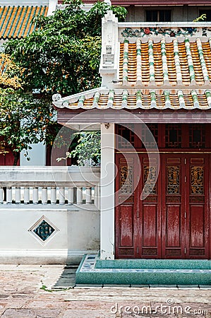 Red old carved wooden Chinese folding door of Wat Ratchaorotsaram Bangkok Stock Photo