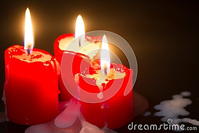 Red old christmas retro candle in the night abstract background Stock Photo
