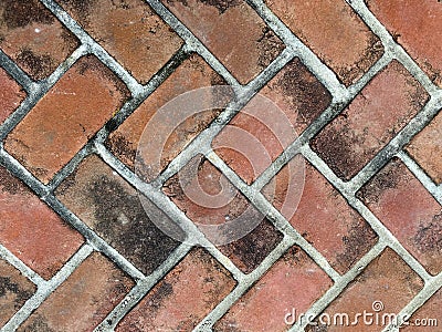 Red old faded dirty close-up cobblestone pattern brick pave Stock Photo