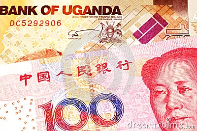 Ugandan currency paired with money from China Stock Photo