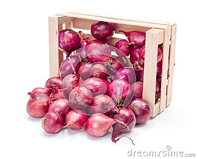 Red onion bulbs in wooden crate Stock Photo