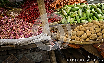 Red onion potato cucumber and red chilli with bamboo wooden basket on traditional market in bogor indonesia Stock Photo