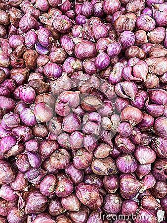 Red Onions are nicely stacked and piled up on this little market Stock Photo