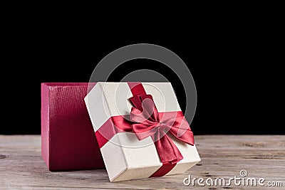 Festive Delight: Red Gift Box with Ribbon on Retro Wooden Desk Stock Photo