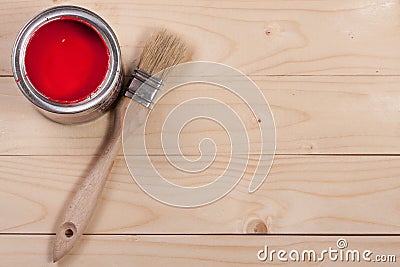 Red paint in the bank to repair and brush on the light wooden background with copy space for your text. Top view Stock Photo