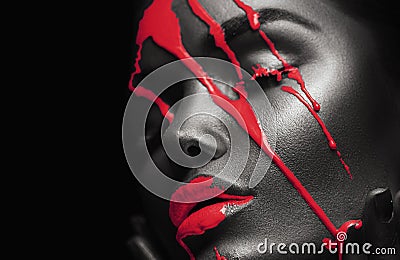 Red Paint smudges drips from African American woman face, lips, eyes. Lipgloss dripping from sexy lips Stock Photo