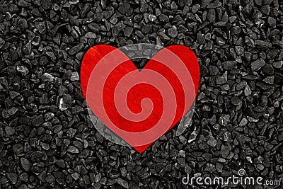 Red painted wooden heart on a grey stones background Stock Photo