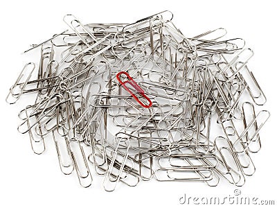 Red paper clip and ordinary clips on white background. Stock Photo