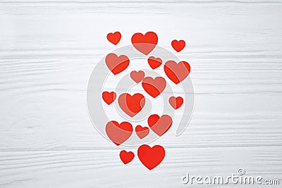 Red paper hearts hanging on white wooden background Stock Photo