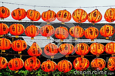 Red paper lanterns of the festival about Chinese people hanging on the rails wall Stock Photo