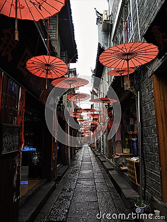 Red Parasols Hanging Over Alley in China Editorial Stock Photo