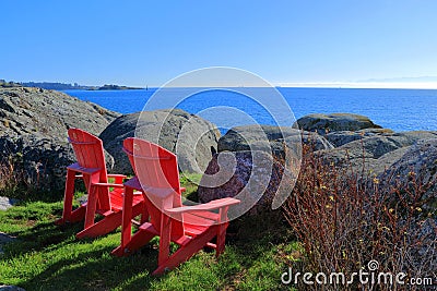 Red Parks Canada Adirondack Chairs at Fort Rodd Hill National Historic Park, Vancouver Island, British Columbia, Canada Stock Photo