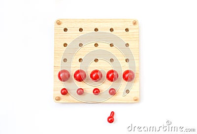 Red pegs board, wood beads on white background Stock Photo