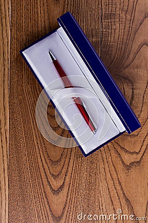 Red pen in a blue gift box. Stock Photo