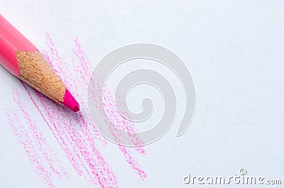 A red pencil draws strokes on white paper. Copy space Stock Photo