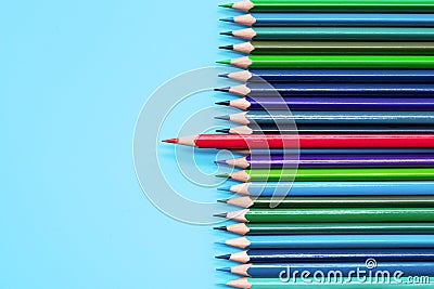 Red pencil standing out on blue background. Leadership, uniqueness, independence, initiative, strategy, dissent, think different, Stock Photo