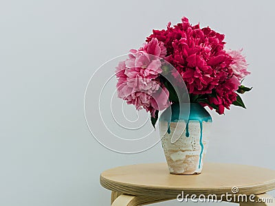 Red peonies in a handmade vase Stock Photo