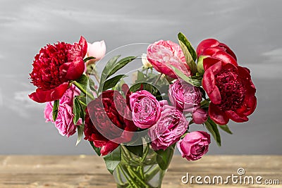 Red peonies in vase. retro styled photo. close-up Stock Photo