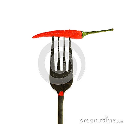 red pepper with drops on a fork isolated on a white background Stock Photo