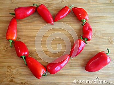 Red Peppers in a Heart on Cutting Board Stock Photo