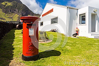 Red pillar postbox, free-standing post box, Post Office and Tourism Centre, Edinburgh of the Seven Seas, Tristan da Cunha island. Editorial Stock Photo