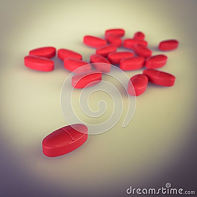 Red pills on gray background and shadow, vintage stye color Stock Photo