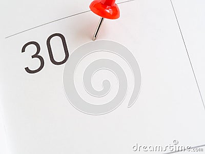 Red pin on 30 calendar paper Stock Photo