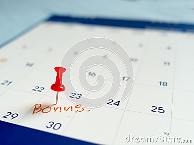 Red pin push on day 30 of end month on white calendar. Mark this day as bonus date Stock Photo