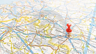 A red pin stuck in Eindhoven on a map of Belgium Editorial Stock Photo