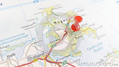 A red pin stuck in the island of Rügen on a map of Germany Stock Photo