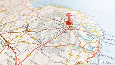 A red pin stuck in Norwich on a map of England Stock Photo