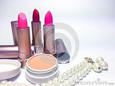 Red and pink moisturizer lipstick in pearl gold Stock Photo