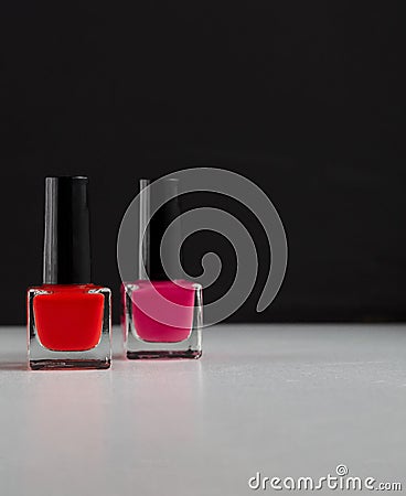 Red and pink nail polish bottles on balck and white background Stock Photo