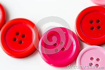 Red and pink sewing buttons on white background Stock Photo
