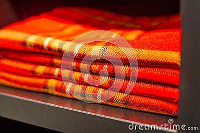 Red plaid checkered lying on a dusty closet shelf Stock Photo