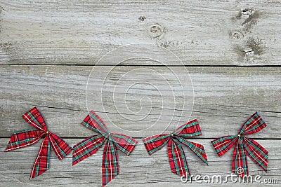 Red plaid Christmas bows border rustic wooden background Stock Photo