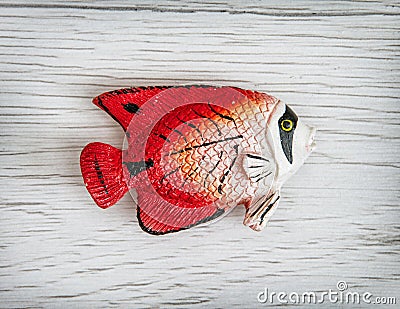 Red plastic fish toy, symbolic object Stock Photo