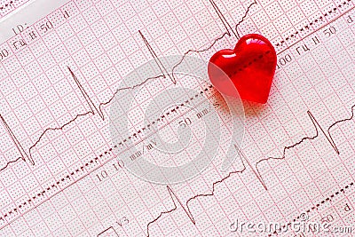 Plastic heart on the background of the electrocardiogram ECG. Stock Photo