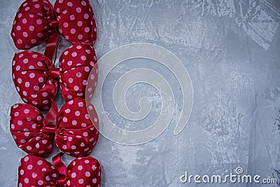 Red polka dot bows. Plush bow A toy. Light background under the concrete. Space for text Stock Photo