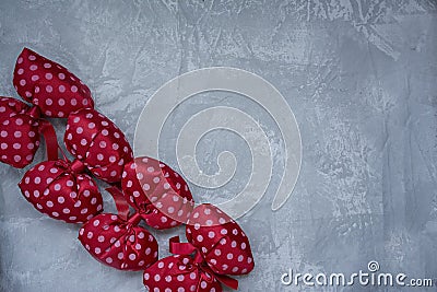 Red polka dot bows. Plush bow A toy. Light background under the concrete. Space for text Stock Photo