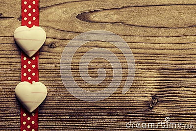 On Red polka dot ribbon, heart-shaped chocolate - wood background Stock Photo