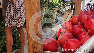 Red pomegranates on the sellers counter and next to the traditional scale Stock Photo